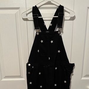 Black overalls with white stars